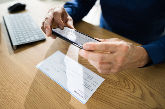 business owner depositing a check