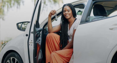 Woman holding keys of new car