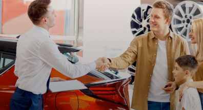 family purchasing a new car at dealership