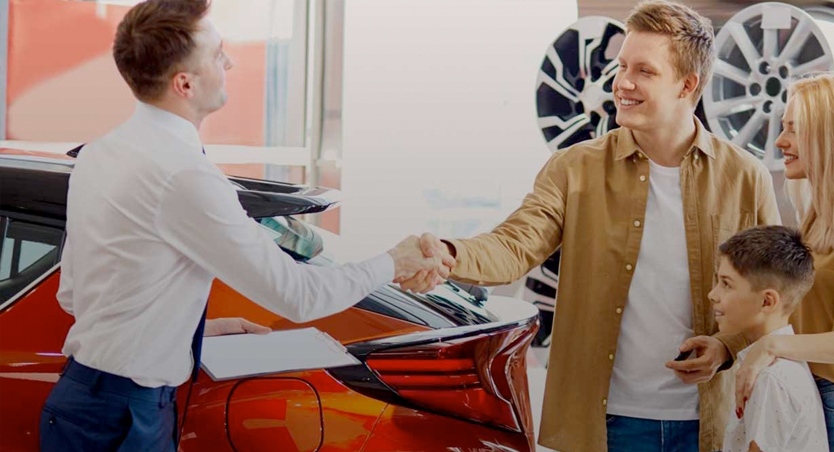 family purchasing a new car at dealership
