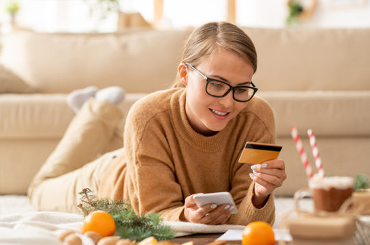 woman on phone with credit card