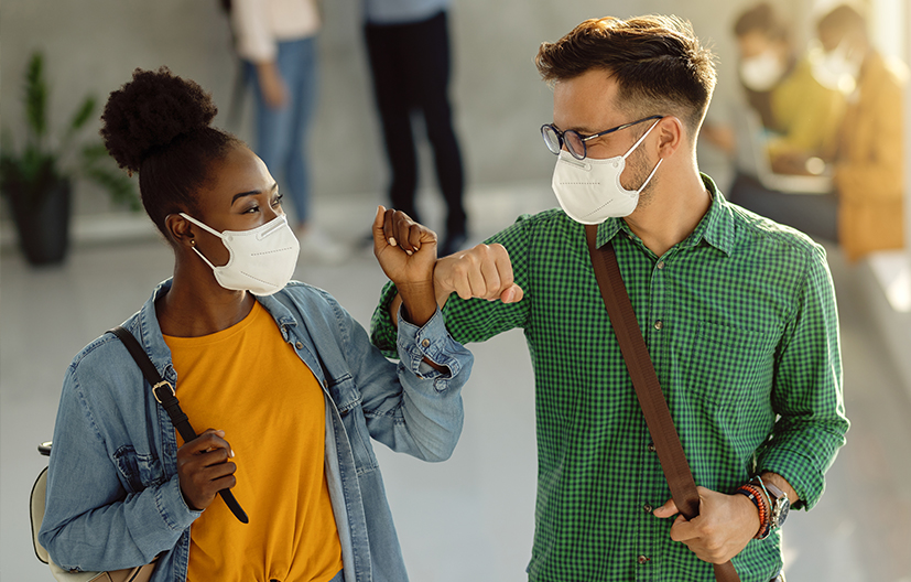co-workers in mask walking down street
