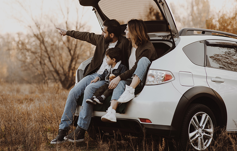family in back of car enjoying scenery