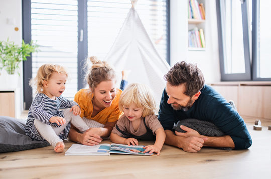 family in living room playing in front of fort
