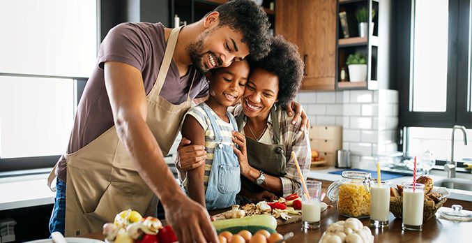 family prepare meal in kitchen