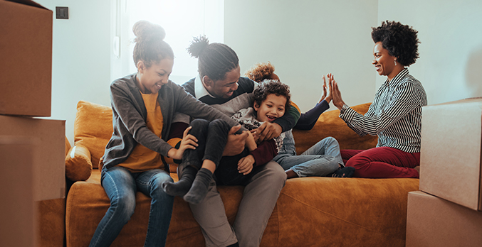 family on sofa of new home