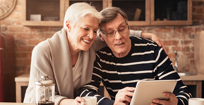 senior couple looking at tablet