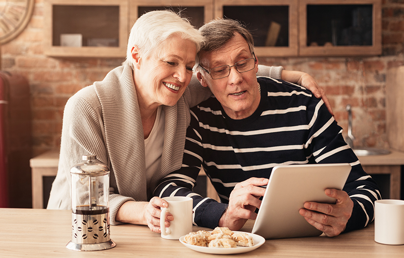 senior couple looking at tablet