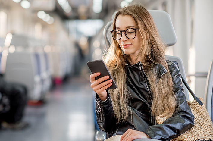 woman banking on mobile on train