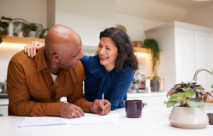 couple looking at paperwork in kitchen