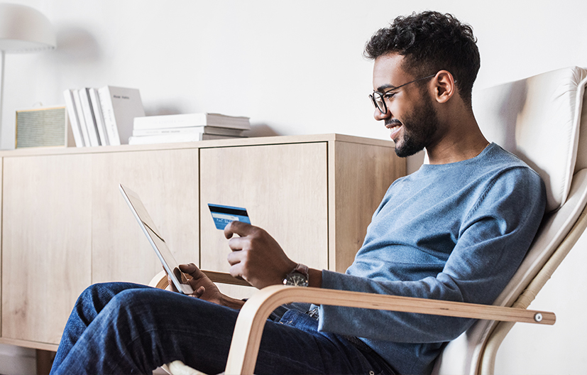 man on computer with credit card
