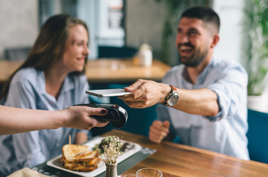 couple paying for lunch with mobile pay