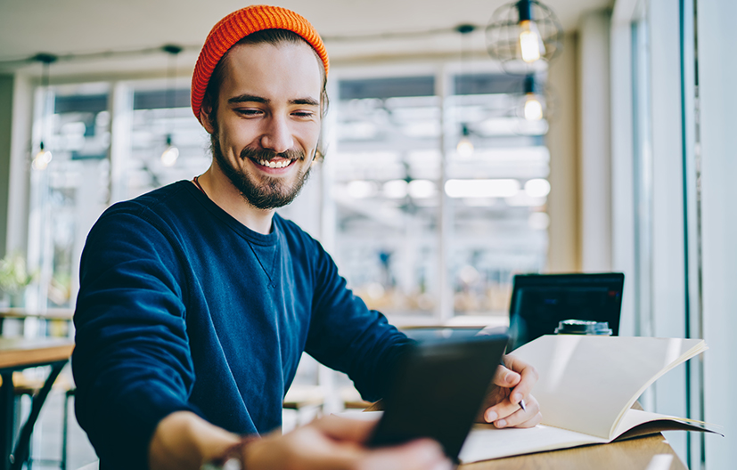 man on cellphone with computer
