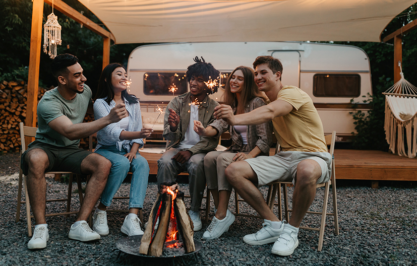 friends at a campfire having fu