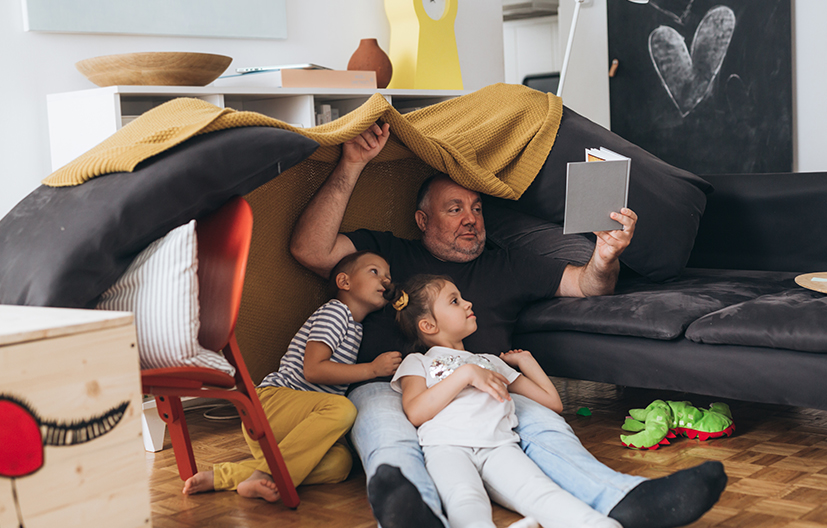 father and children in living room fort
