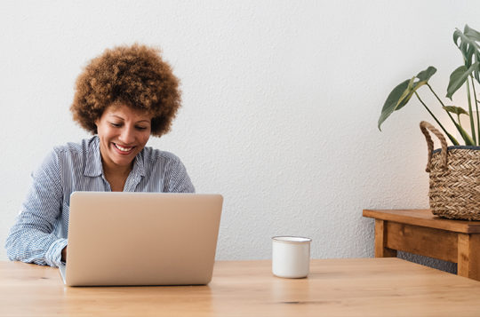 woman on computer with coffee